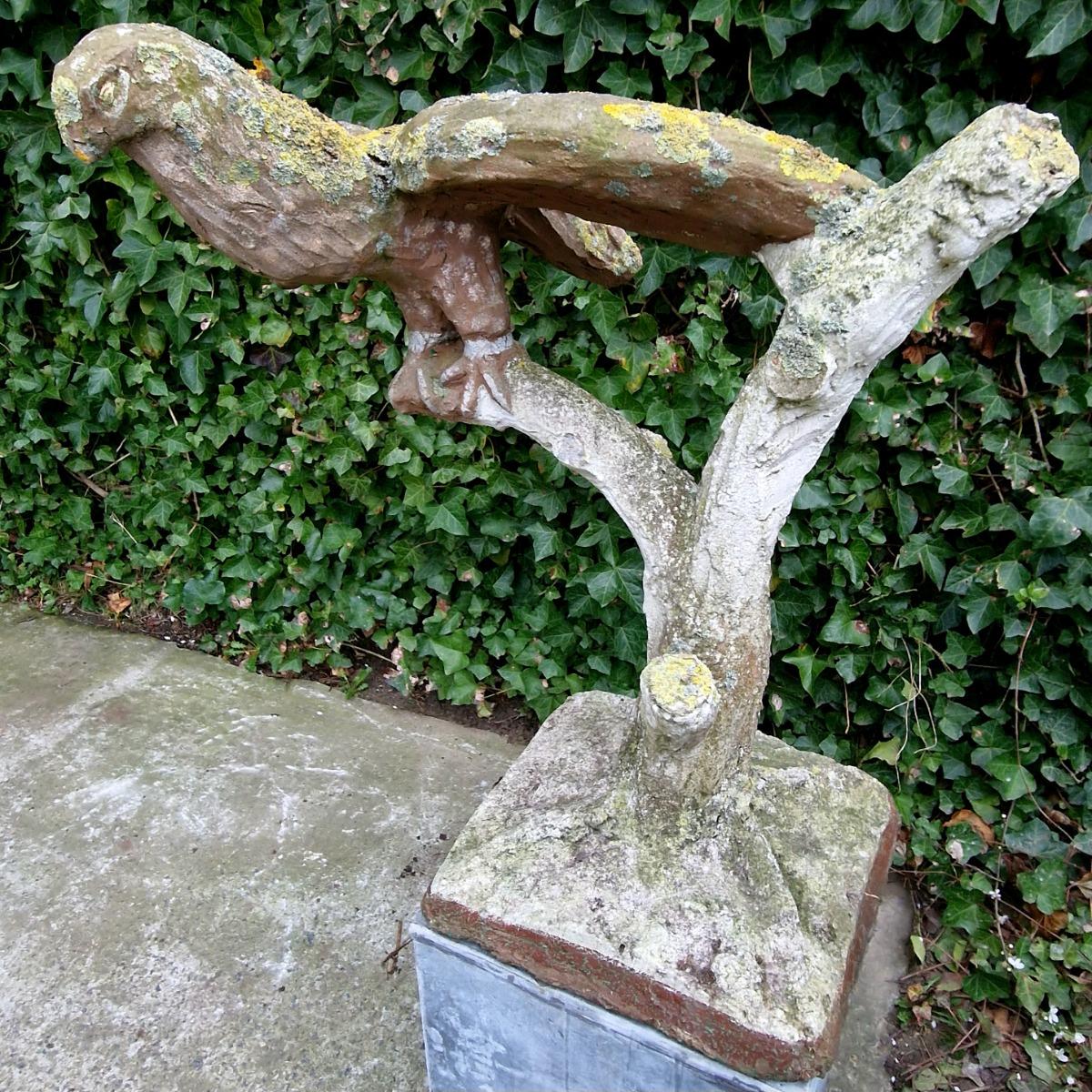 Cement bird on branch