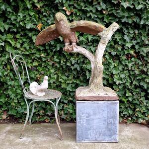 Cement bird on branch