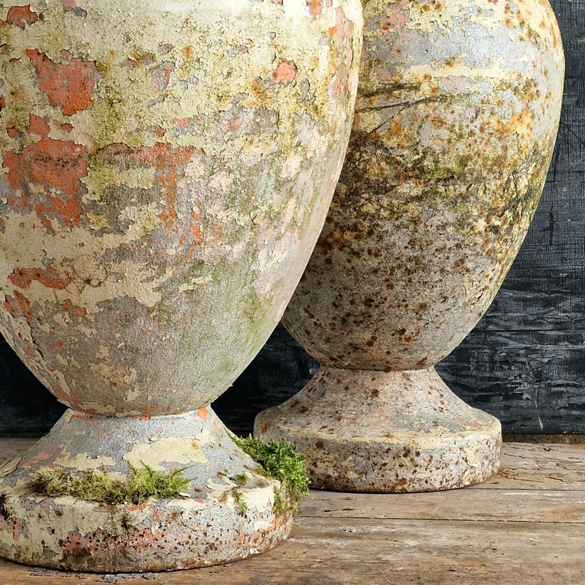 Pair of cast iron urns