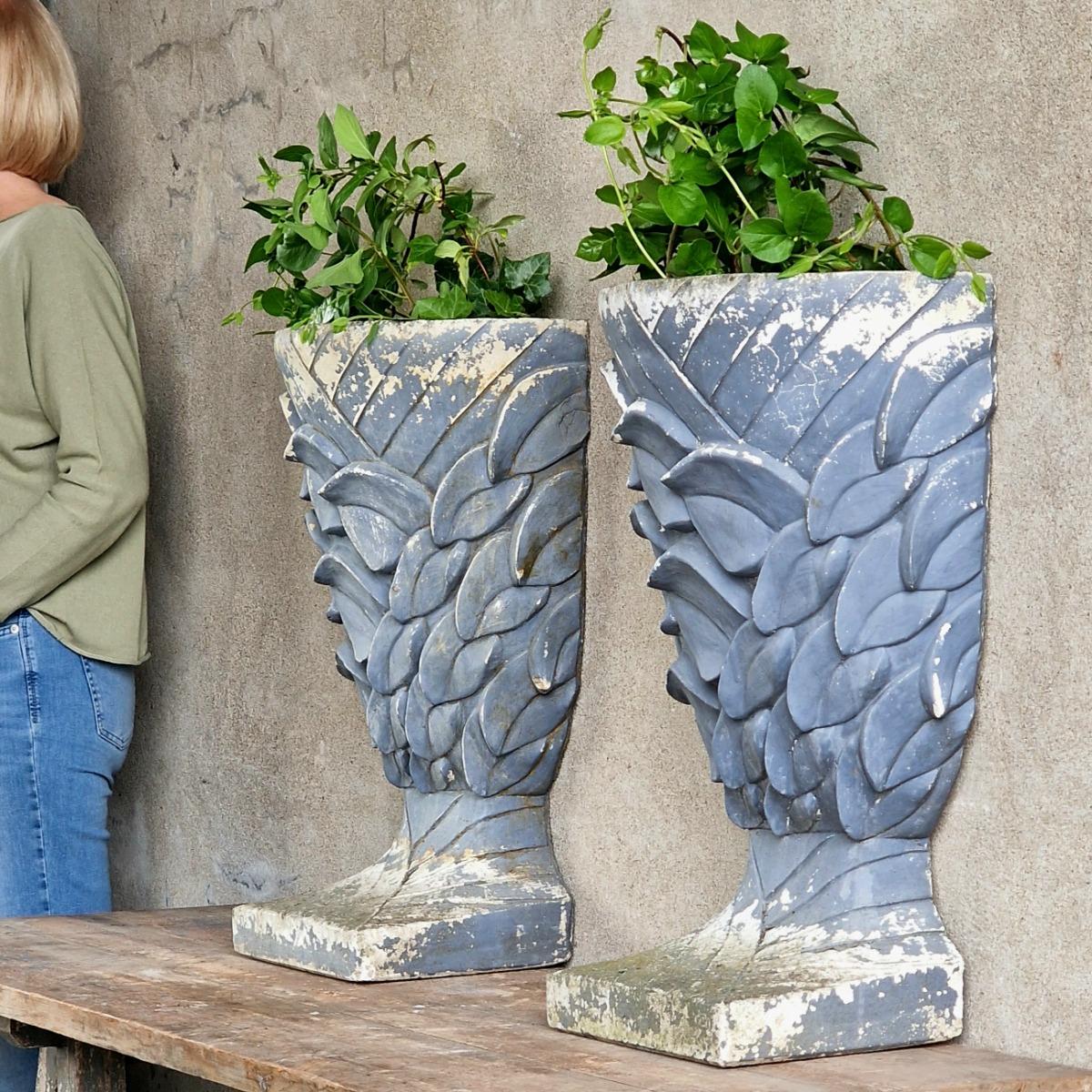 Pair of enigmatic wall planters