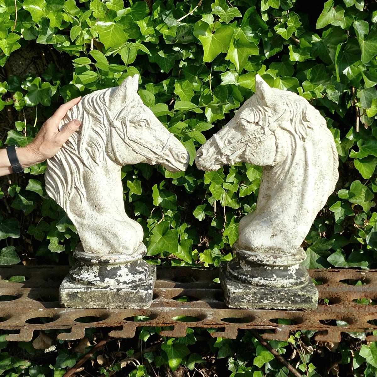 Two cast stone horse heads
