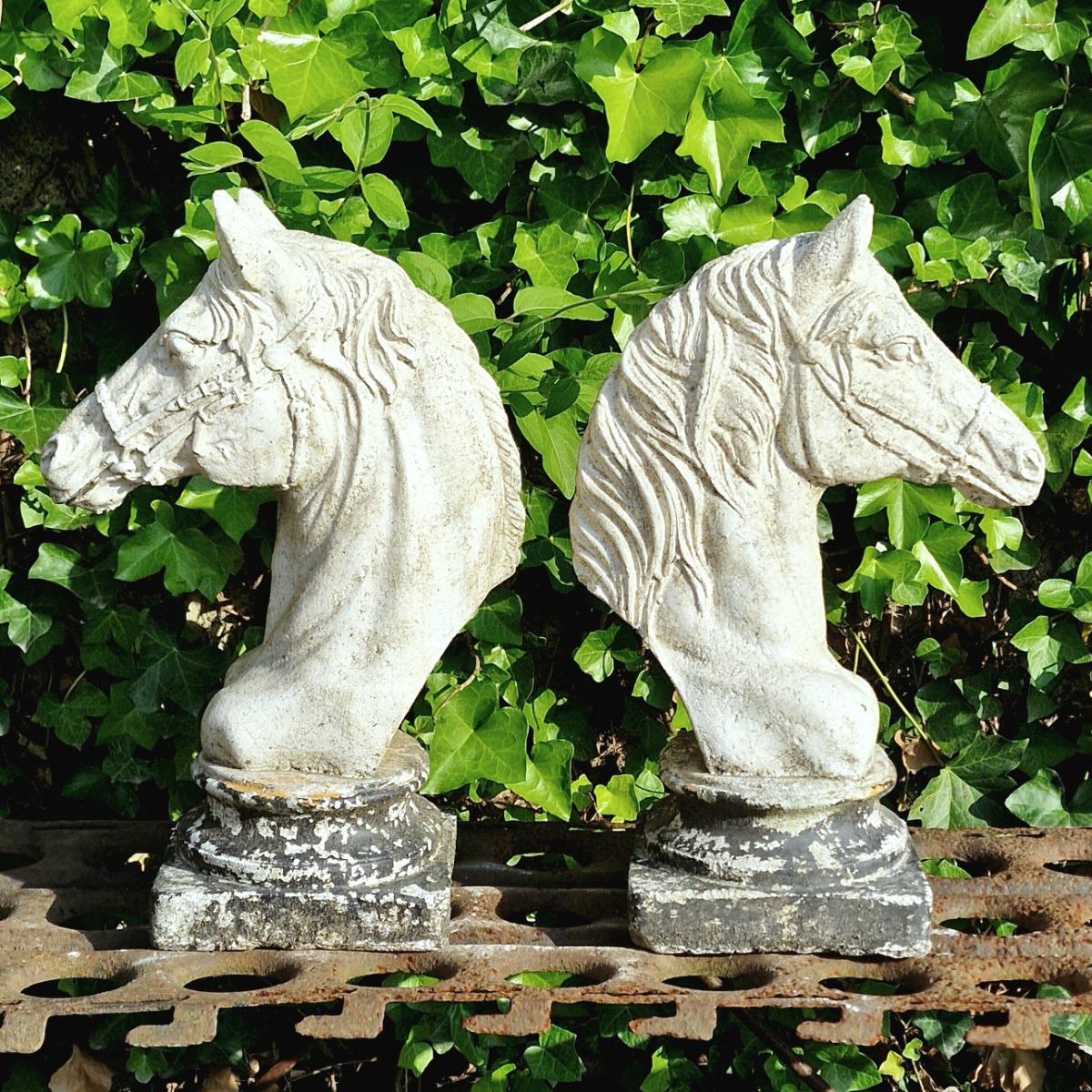 Two cast stone horse heads