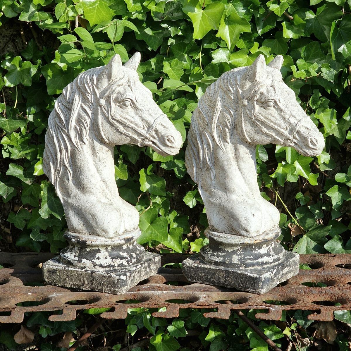 Two cast stone horse heads
