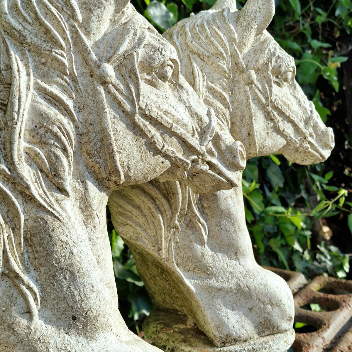 Two cast stone horse heads