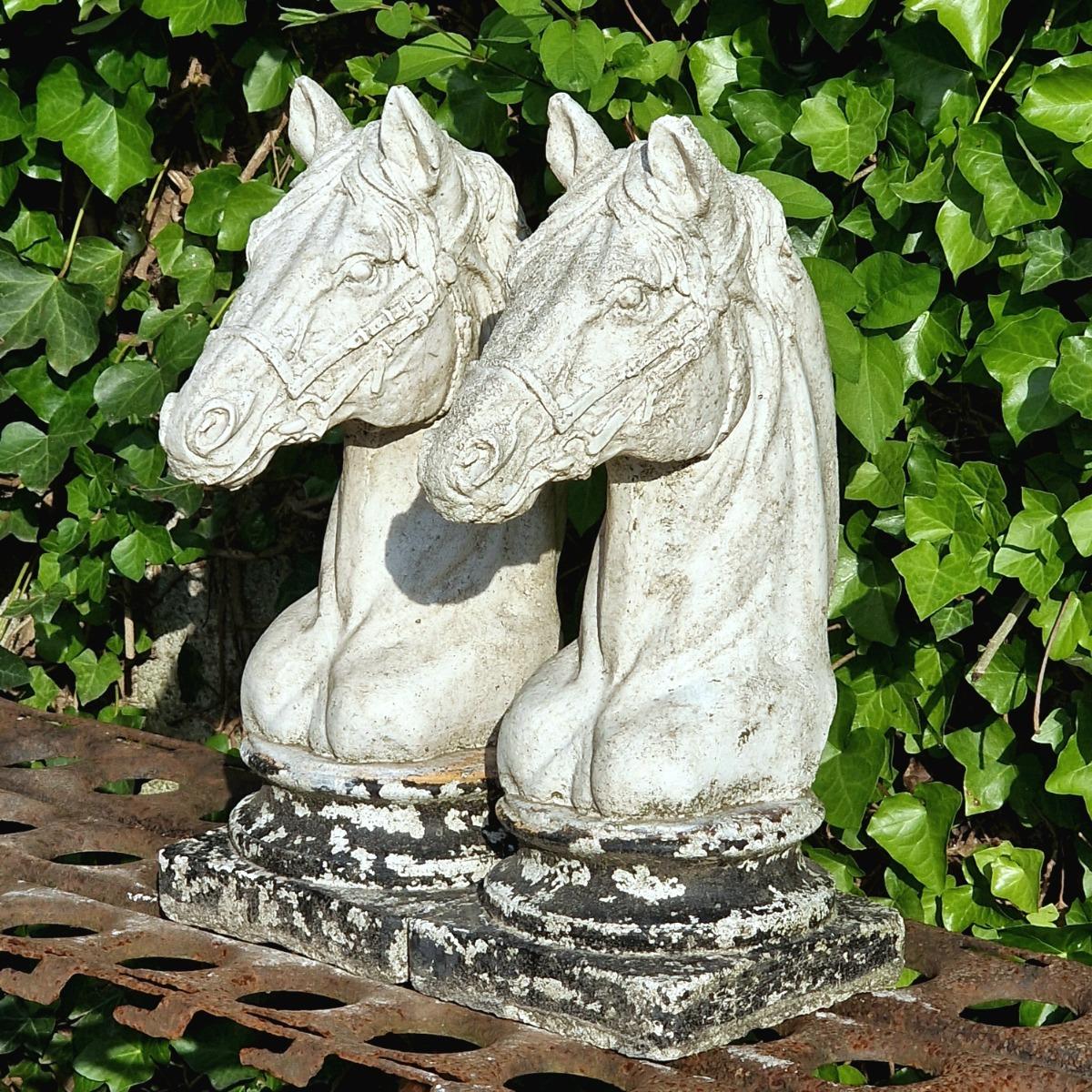 Two cast stone horse heads